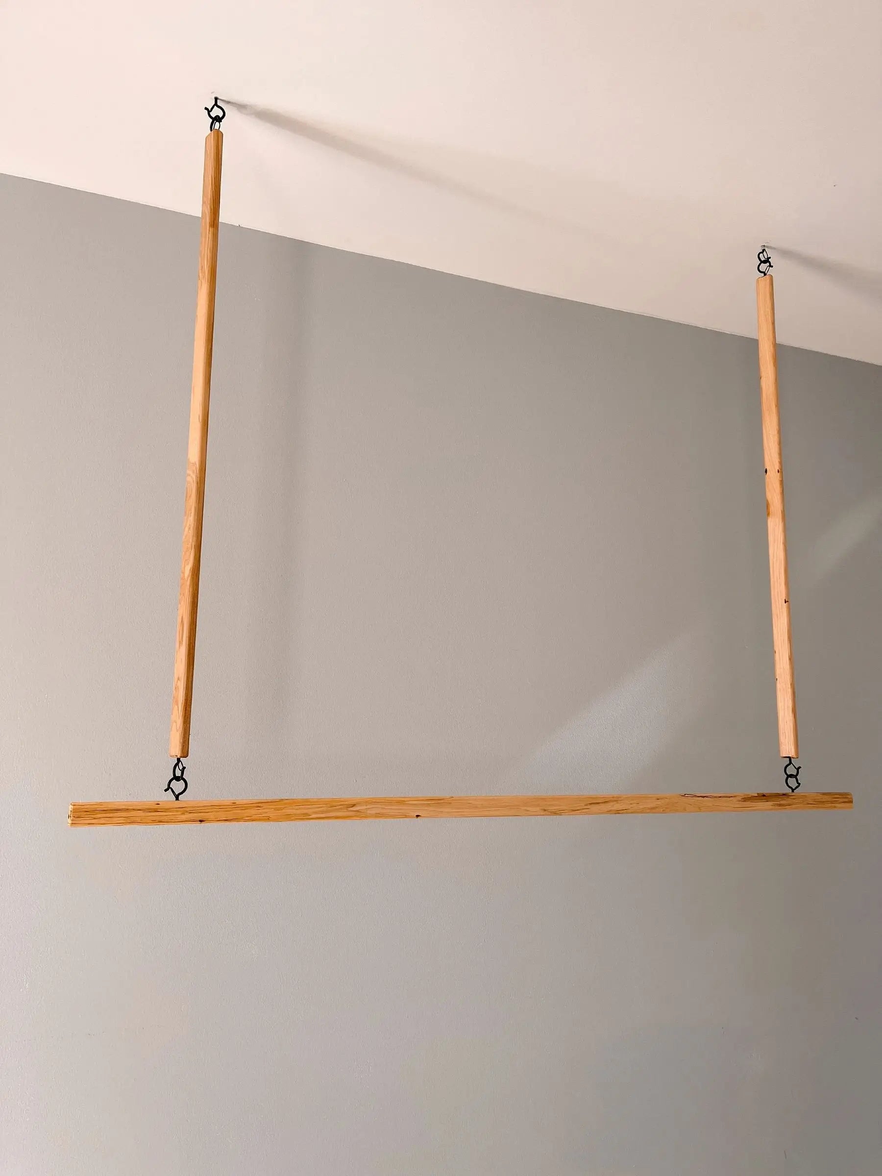 Suspended wooden rack mounted to ceiling – space-saving and stylish home organizer