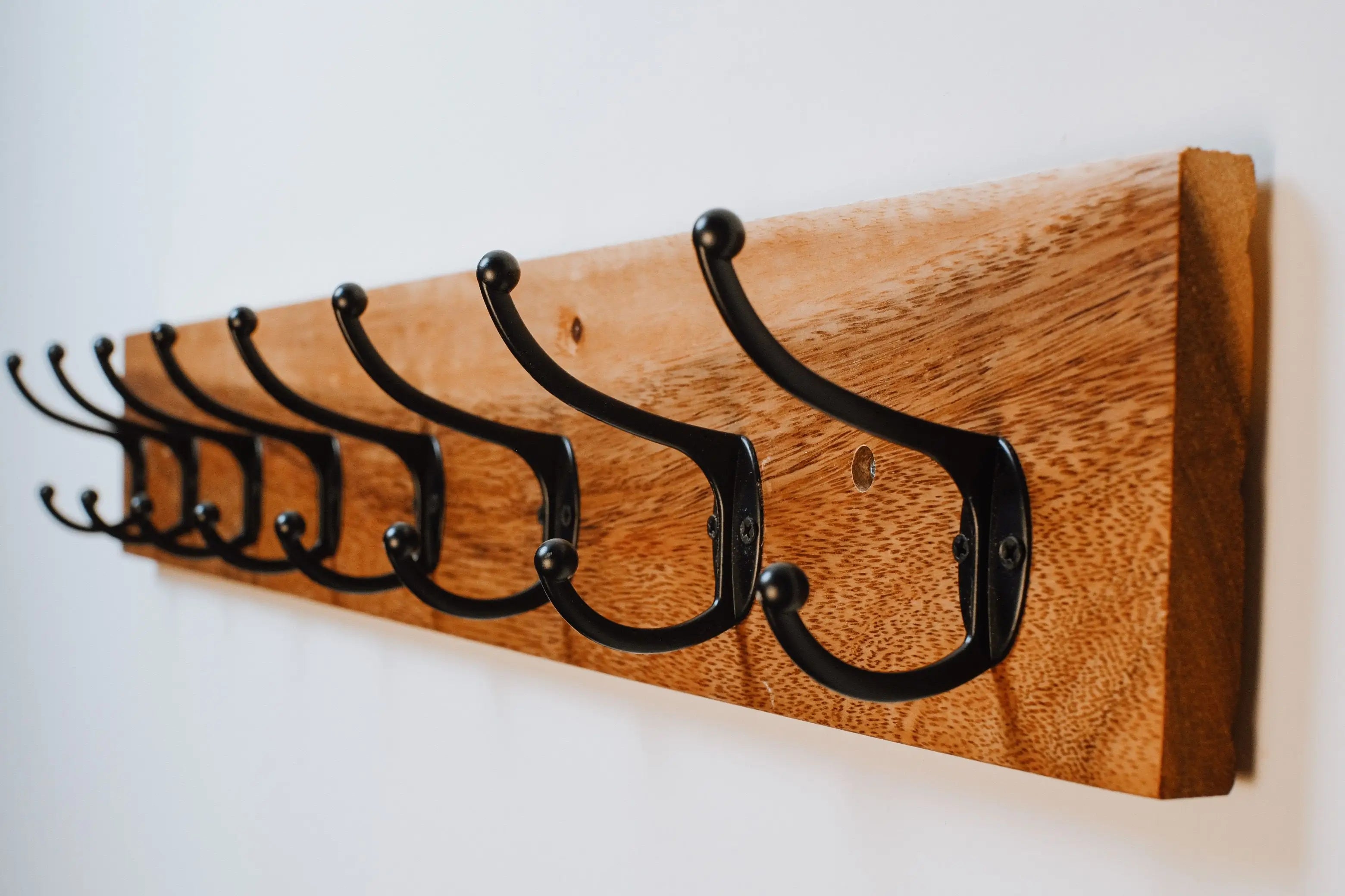 Wall-mounted coat rack with metal hooks – handcrafted from rich acacia wood