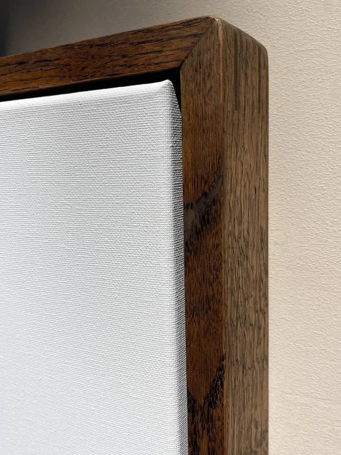 Minimalist oak wood floating frame with canvas artwork on white wall