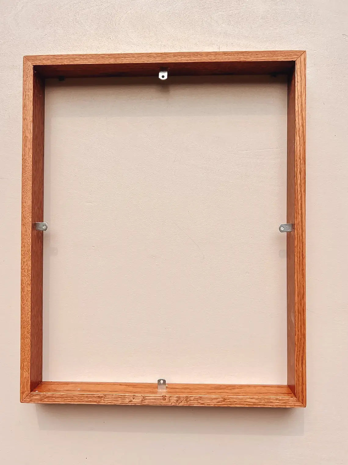 Fully assembled oak hardwood frame holding stretched canvas painting