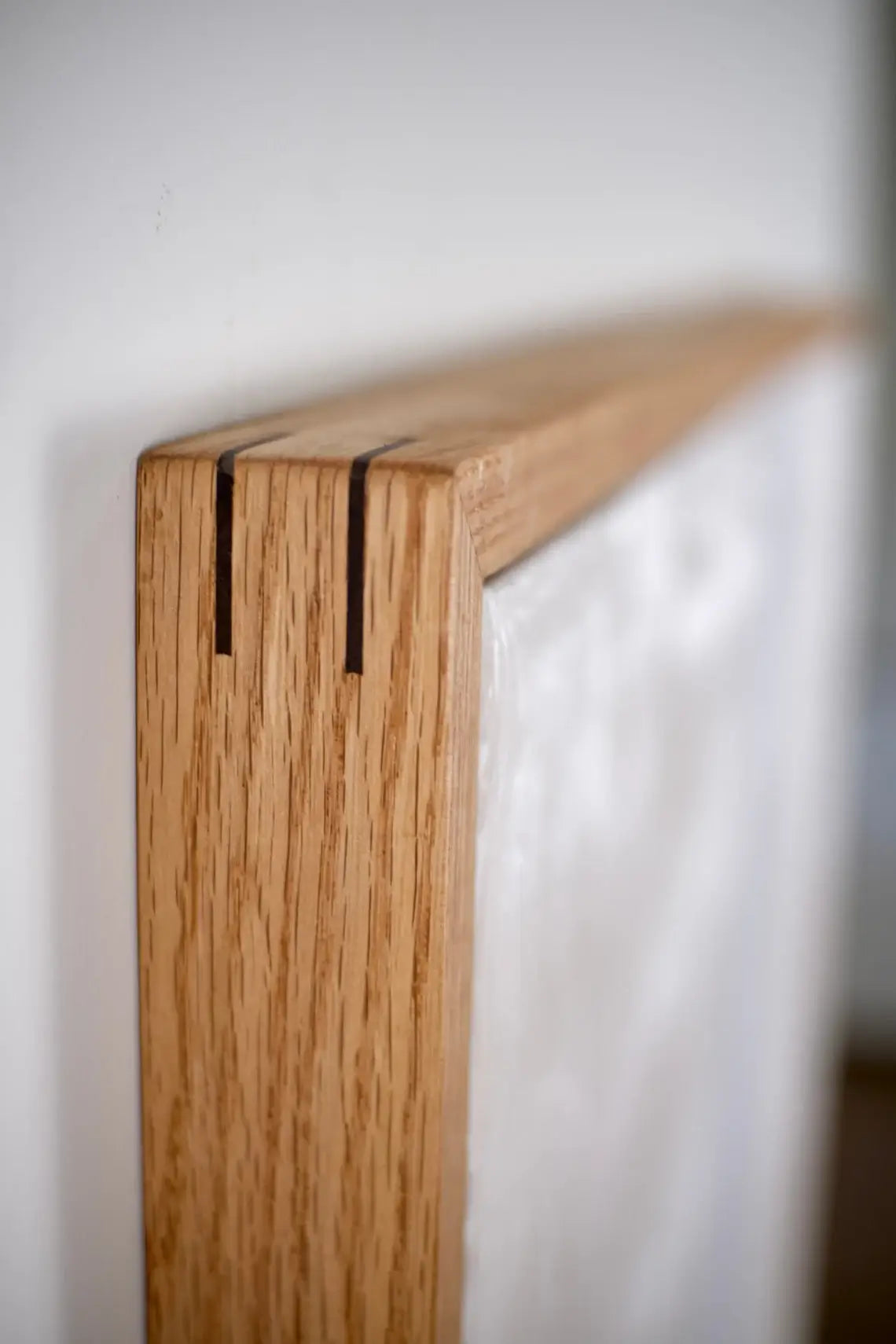 Framed canvas artwork in light oak wood floating frame