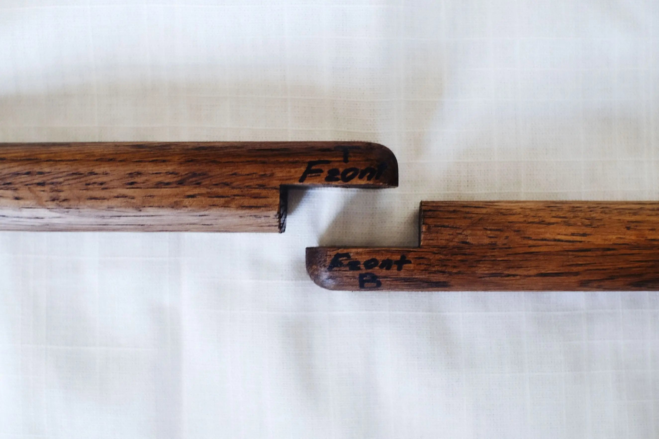 Two wooden handles with engraved text on a white background