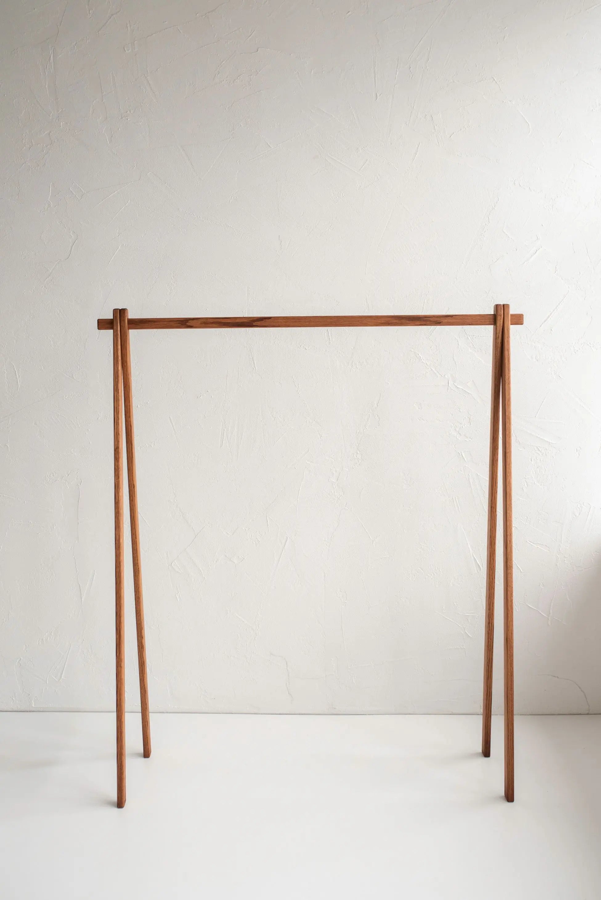 Wooden clothing rack on a white background