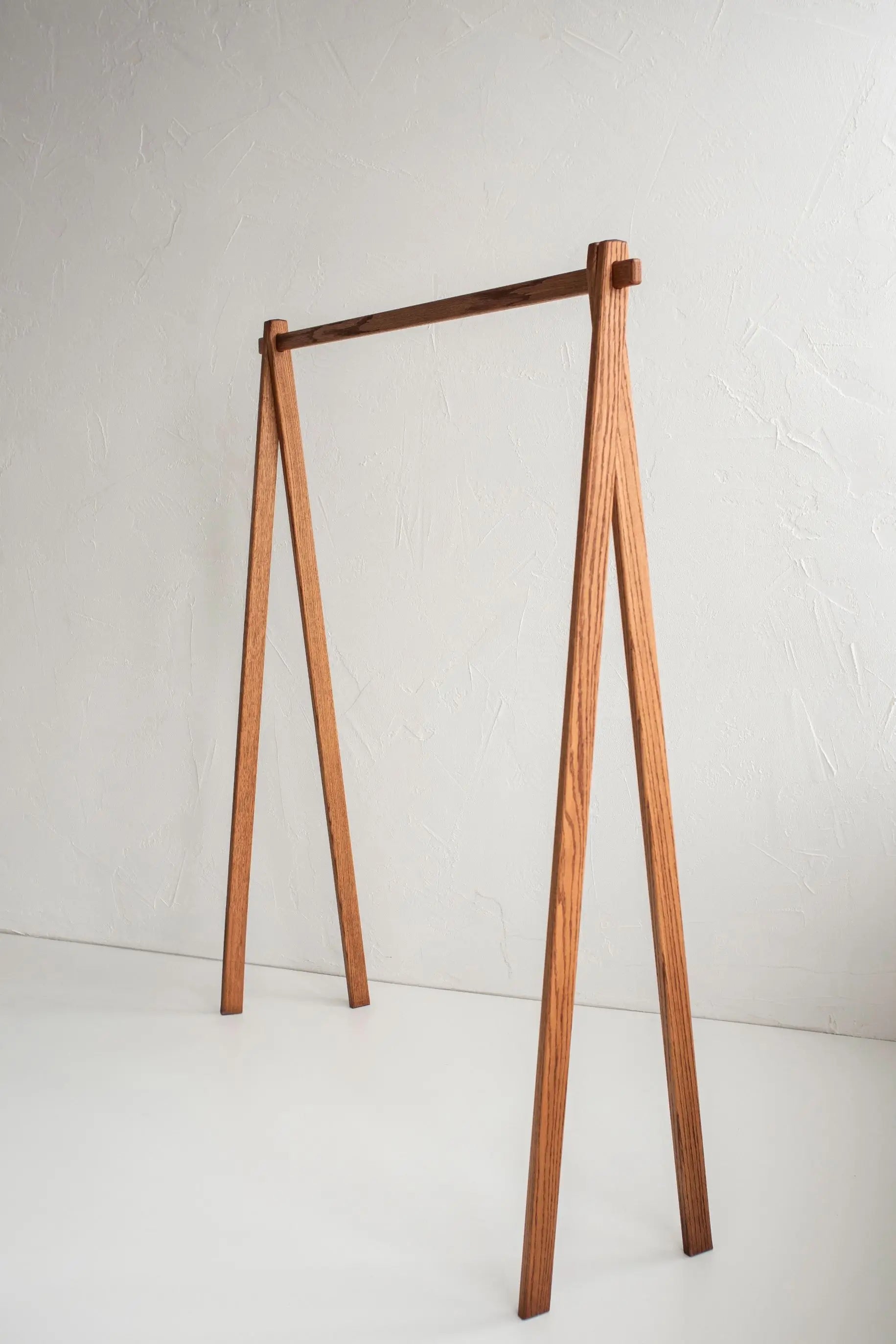 Wooden clothing rack on a white background