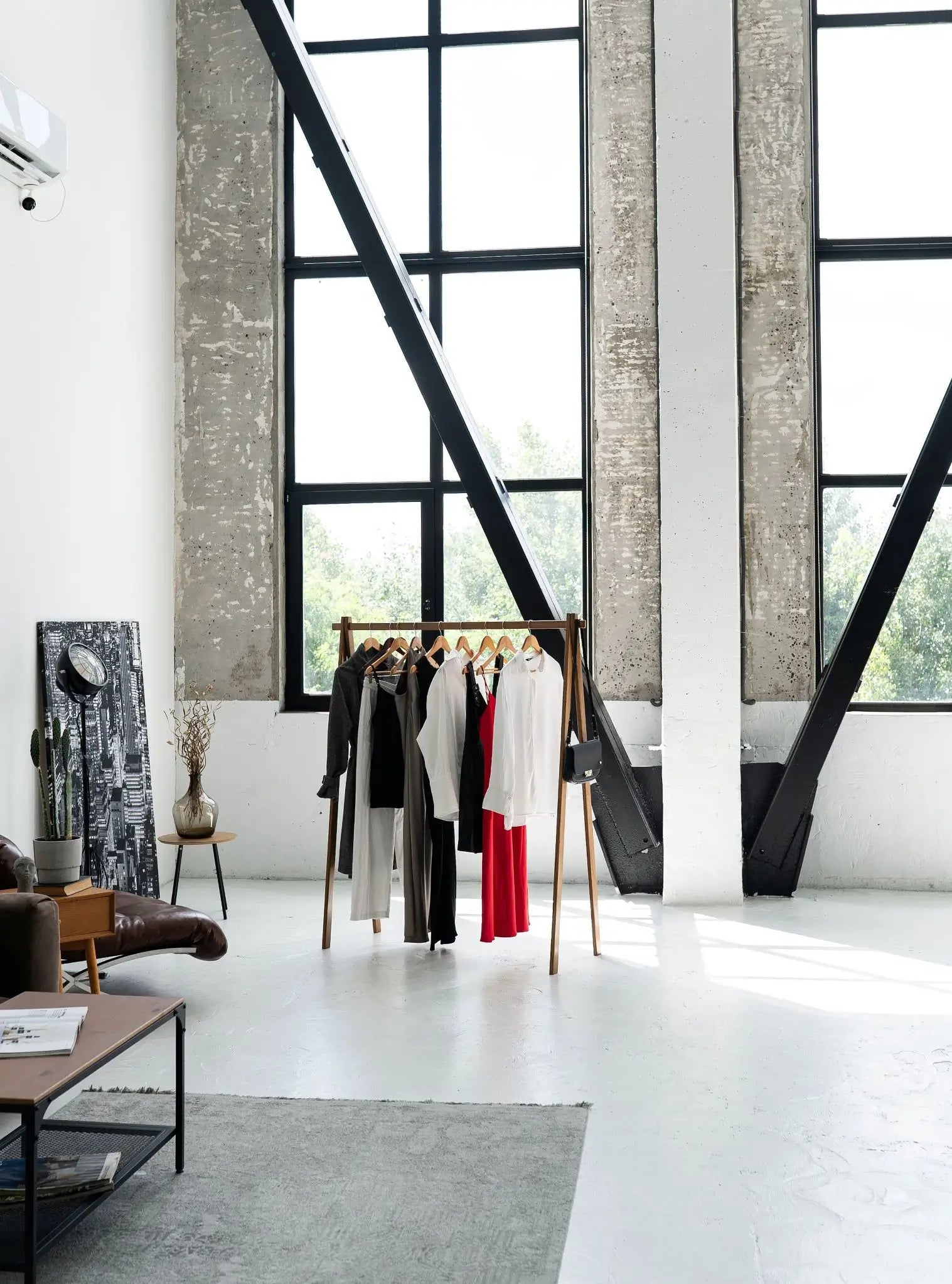 Modern interior with clothing rack against a large window