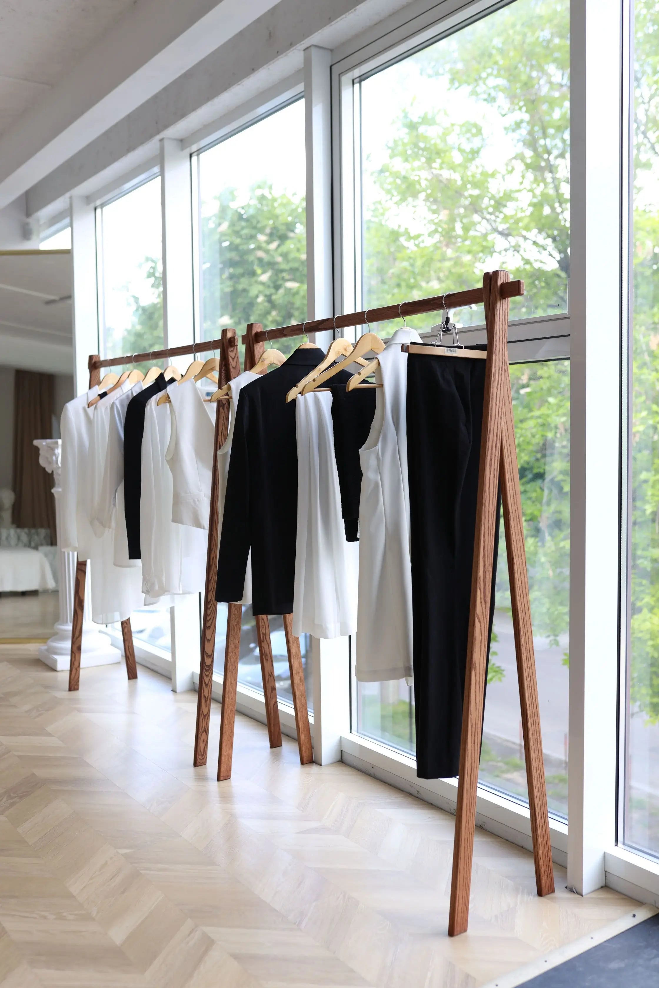 Clothing rack with clothes in a room with large windows