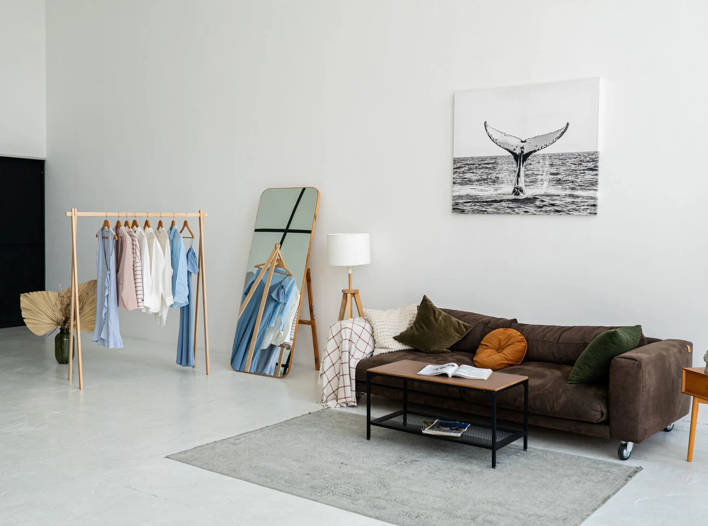 Modern living room with a brown sofa, coffee table, and decorative items.