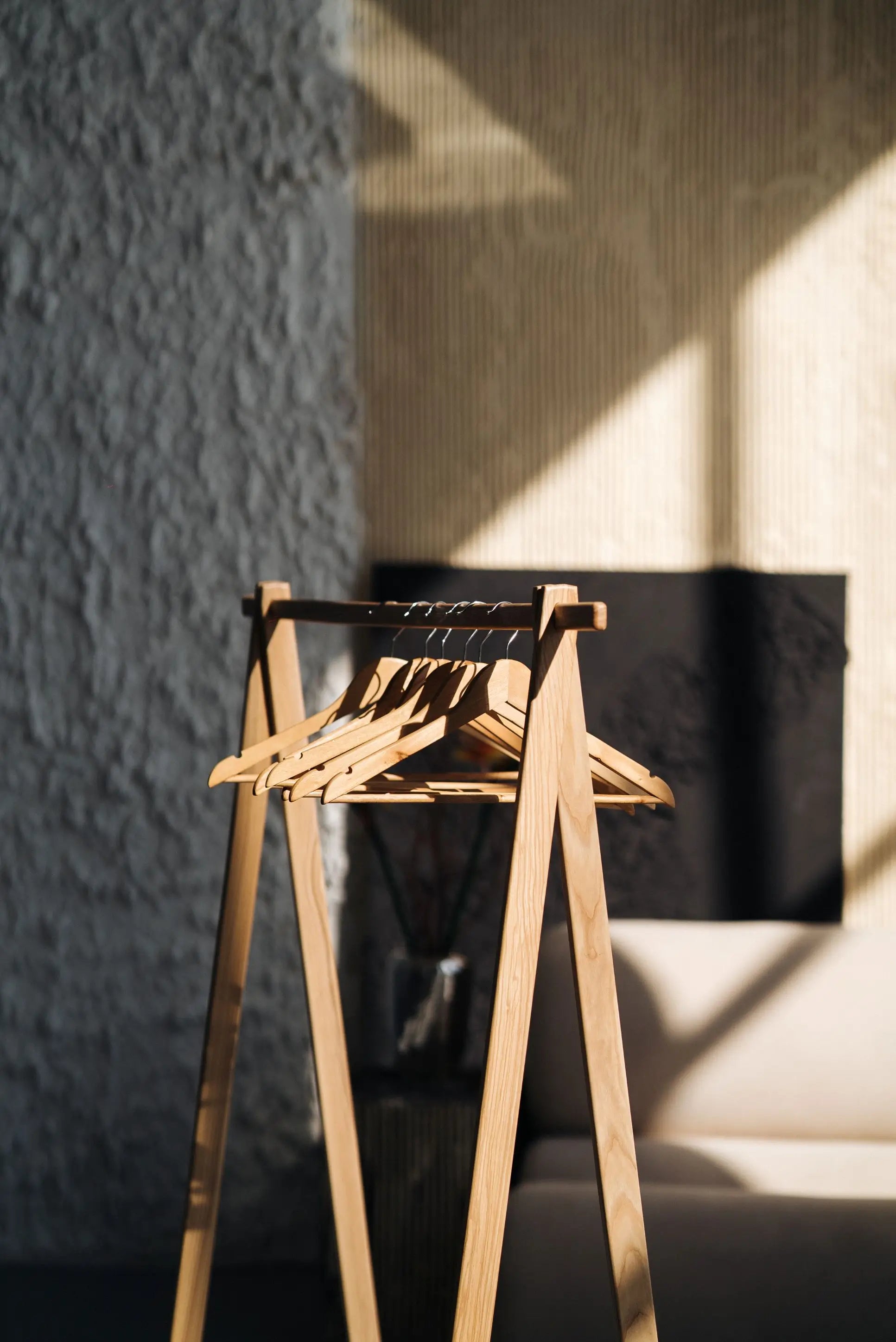 Wooden chair against a textured wall with shadows