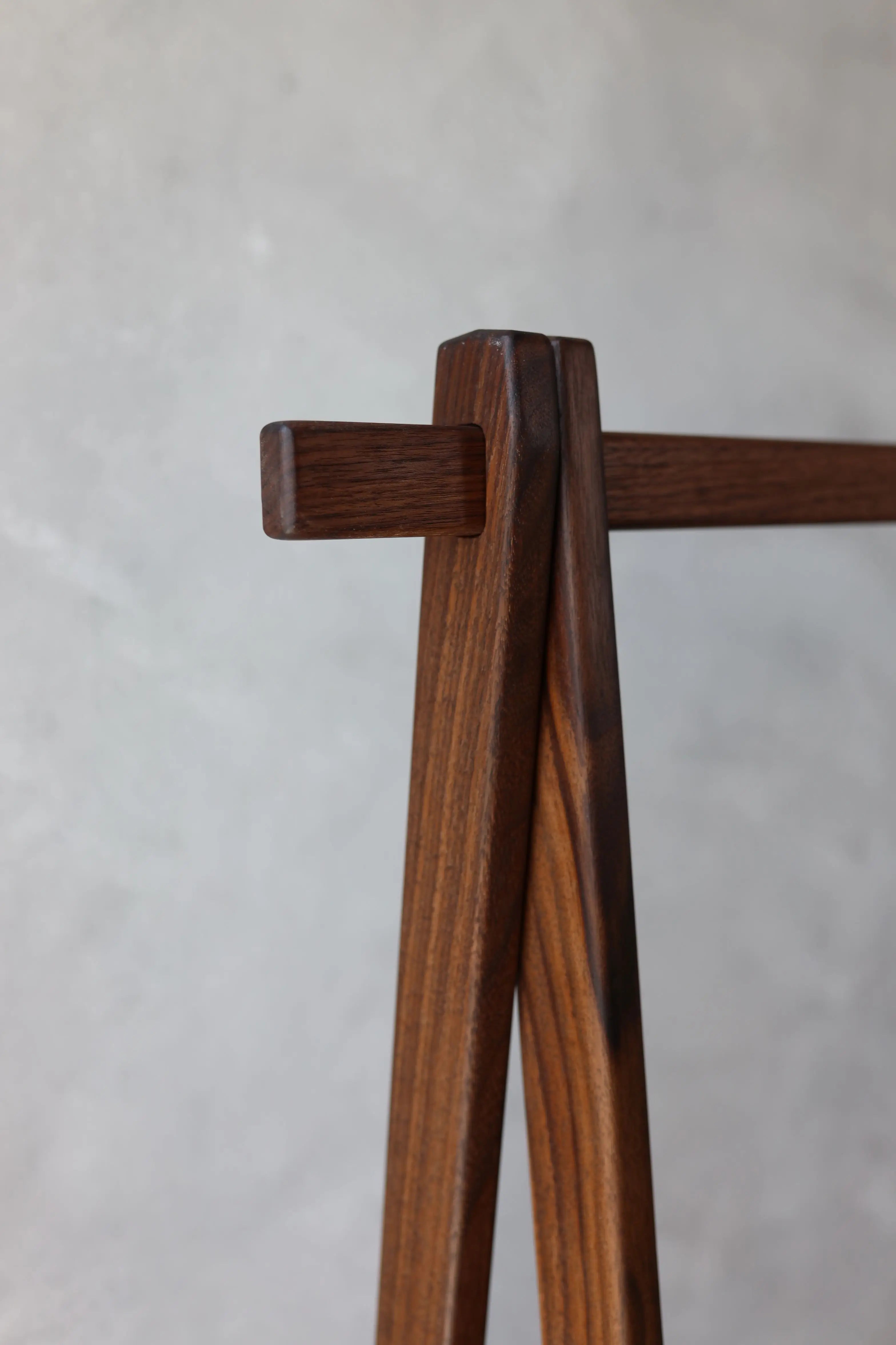Wooden coat rack on a light gray background