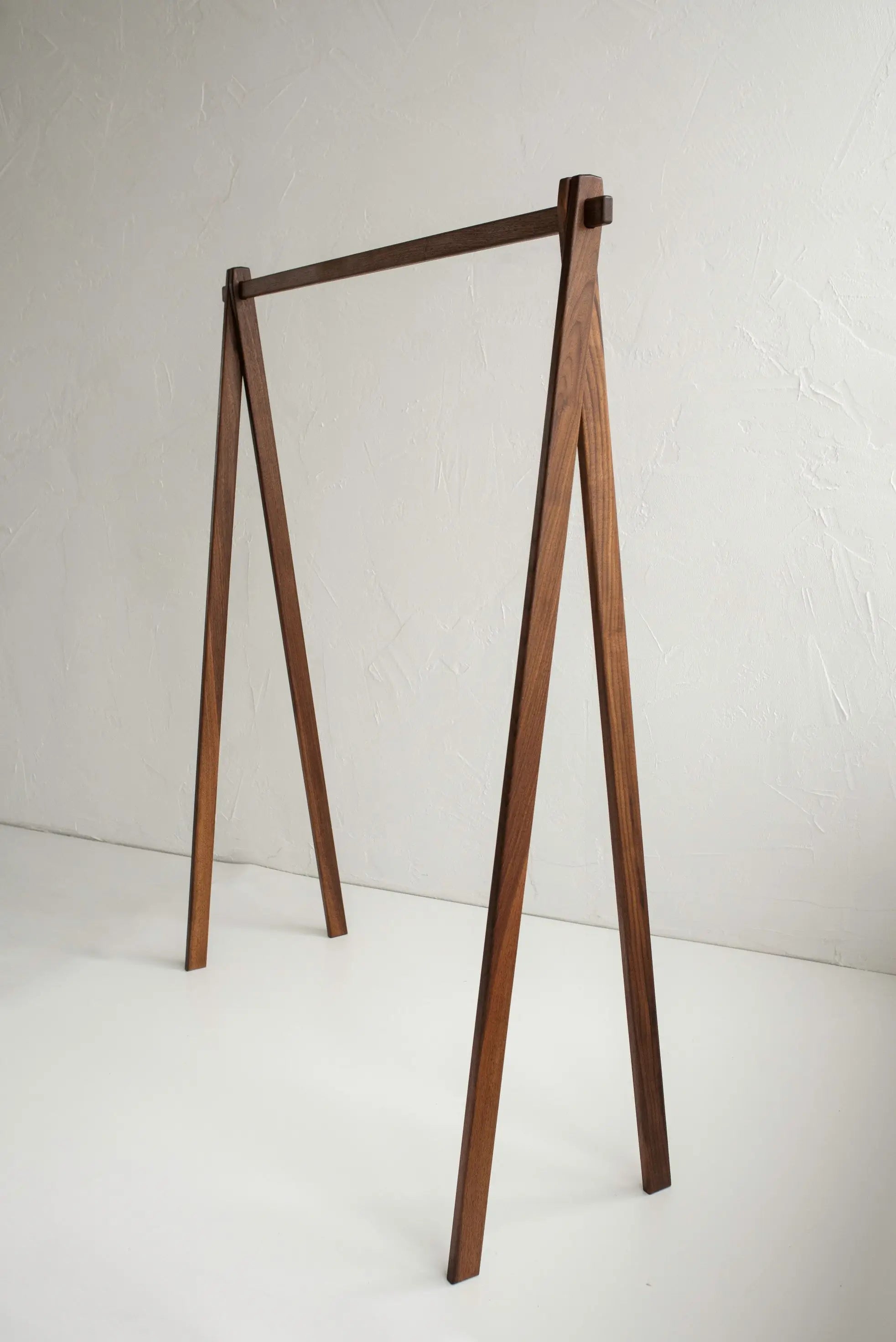 Wooden clothing rack on a white background