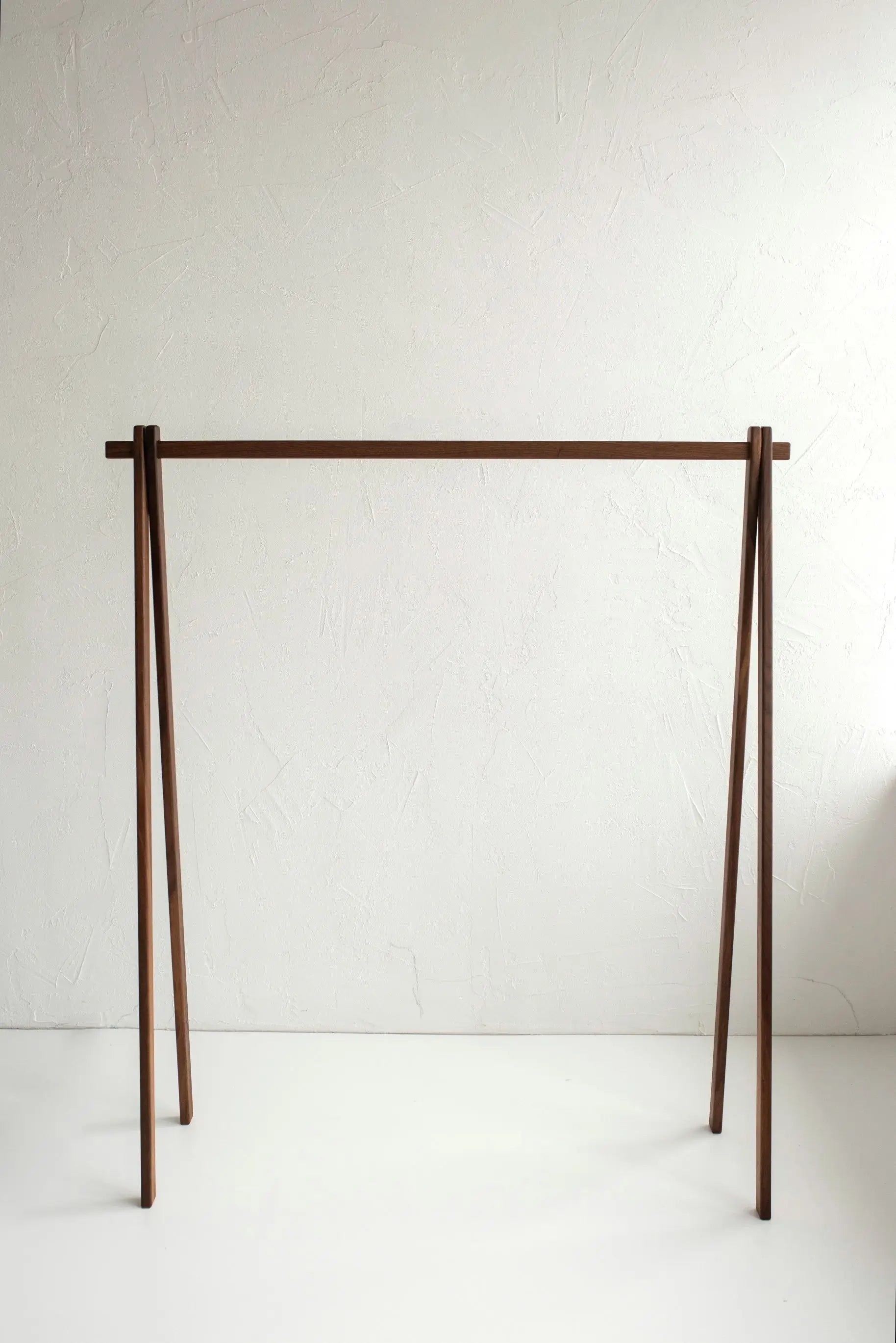 Wooden clothing rack on a white background